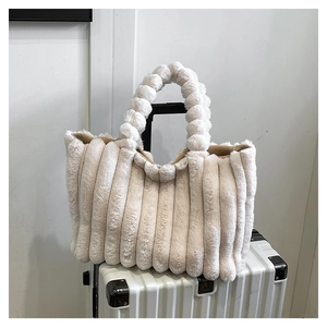 Close-up of fluffy cream tote bag featuring soft faux fur with vertical stripe texture