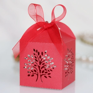 Detailed laser cut ivory paper candy box with life tree pattern and silk ribbon
