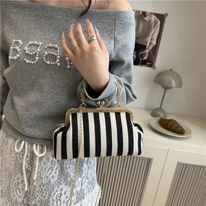 Chic black and white striped woven shell bag with vintage gold metal frame and chain strap