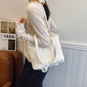 Elegant white lace tote bag with floral crochet and leather straps for summer beach vacations