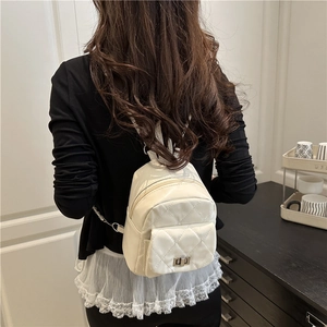 Chic white quilted mini backpack with metal chain straps and front turn-lock pocket