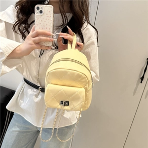 Quilted light yellow mini backpack with chain strap and metallic twist lock detail