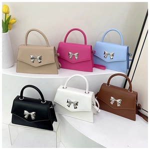 Detailed view of square handbags with metallic silver bows in six elegant colors