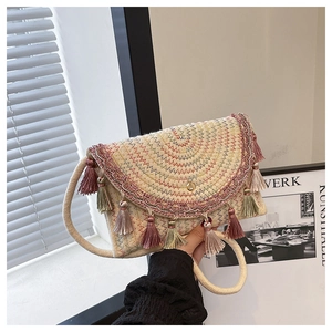 Detail of hand-woven saddle bag featuring colorful fringe tassels and wave stitching