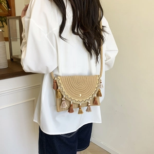 Ethnic straw saddle bag with colorful tassels and embroidery for summer vacation