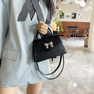 Fashionable black faux leather crossbody bag with silver metal bow and top handle