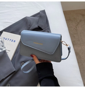 Detail of blue flap and grey woven texture bag with Fashion & Bags lettering