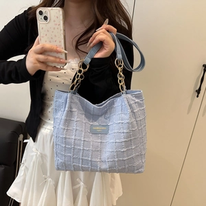 Light blue plaid woven tote bag with gold chain strap and elegant texture for women