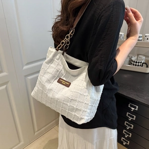 White quilted tote bag with chain strap and leather patch for women casual commute