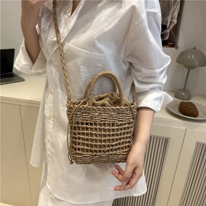 Handwoven straw bucket bag with drawstring liner and long shoulder strap for women