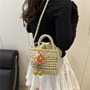 Handmade woven straw shoulder bag with crochet floral accents and cherry charm