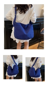 Detail of navy blue large capacity crossbody bag with adjustable strap on model