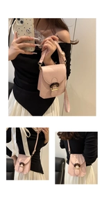 Detail of pink PU leather small phone bag showing retro wooden buckle and shoulder strap