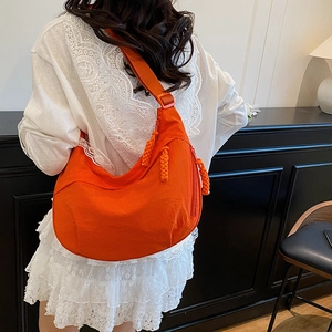 Bright orange nylon dumpling crossbody bag with large capacity and adjustable strap