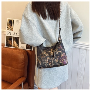 Macro detail of vintage floral patterned crescent bag with elegant Xiangyun silk texture