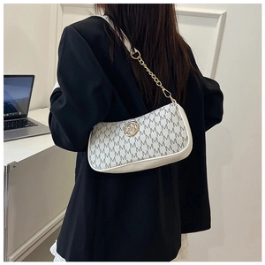 Detail showing white crescent moon bag with golden metal M logo and letter print monogram