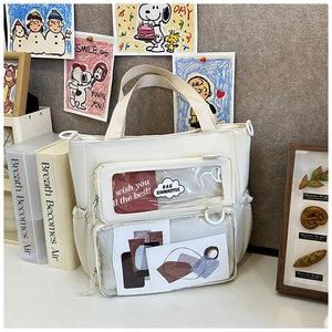 Detail of white tote bag with double clear PVC pockets for badges and accessories