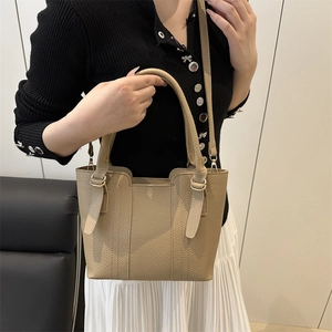 Chic beige textured leather tote bag with metallic hardware and shoulder strap for women