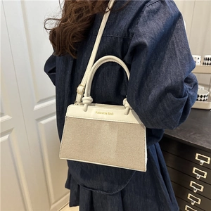 Minimalist beige crossbody handbag with top handle and Fashion Bag print for women