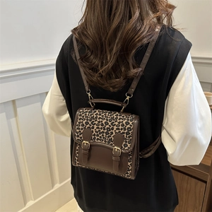Chic leopard print backpack with faux leather trim and retro gold buckle design