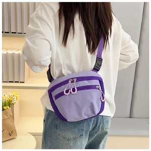 Detail of purple checkered crossbody bag featuring high-density nylon and plastic zippers