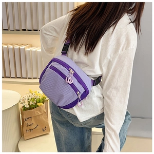 Detail view of purple checkered crossbody bag with multiple zipper pockets and nylon texture