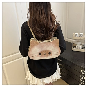 Detail view of a cat-shaped crossbody bag worn by a model in a minimalist room