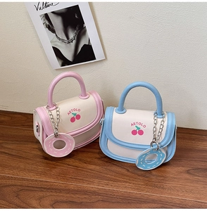 Close-up of AETOLO mini handbags with cherry prints and cute donut charms