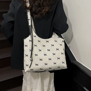 Sweet polka dot canvas shoulder bag with bow pattern and wide straps for daily casual use