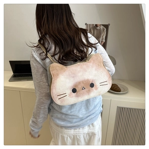 Rear view showing the cute cream cat tote bag worn over the shoulder for daily style