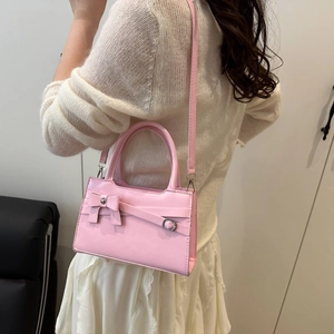 Pink crossbody bag with decorative bow and adjustable strap for elegant daily style