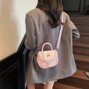 Chic pink and beige crossbody bag with cute cherry print and donut charm decoration