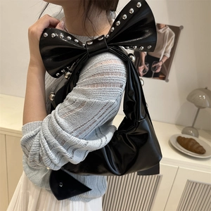 Trendy black bow-shaped underarm bag with silver rivet studs for a stylish 2025 look