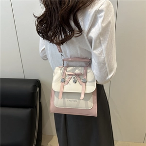 Pink and beige crossbody bag with butterfly bow and heart pendant on model