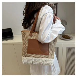 Macro view of large woven tote bag with brown PU pocket and beige straw texture detail