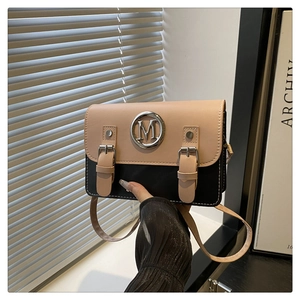 Chic two-tone square crossbody bag in beige and black with metallic M buckle and thin strap