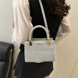 Silver grey snake print tote bag with woven handles and golden metal hardware