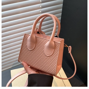 Pink woven texture mini square bag with top handles and slender crossbody strap
