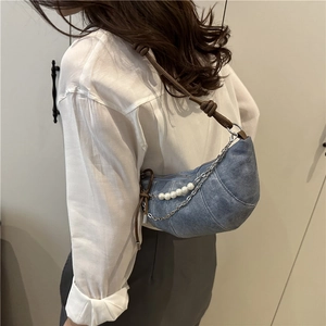 Retro denim crescent shoulder bag with pearl accents and knotted brown leather strap