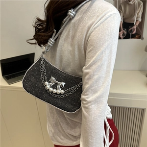 Sparkly dark gray butterfly chain baguette bag shown in a lifestyle side view