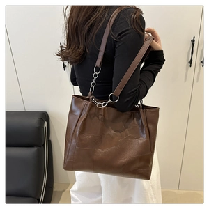 Detailed back view of a large vintage brown patchwork leather tote bag with silver hardware