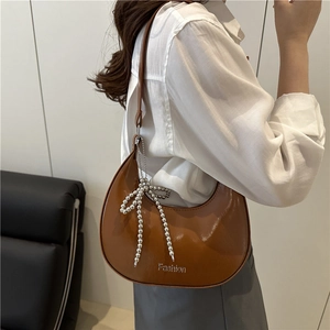 Brown semi-circle hobo bag with silver beaded bow charm and fashion typography print