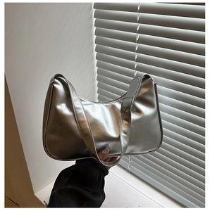 Close-up of metallic silver hobo bag with textured leather and adjustable shoulder strap