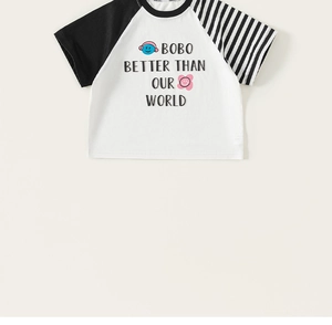 Detail of kids cotton T-shirt featuring letter print and contrast raglan sleeves