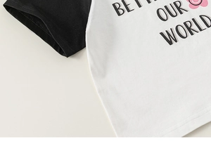 Detail view of cotton raglan sleeve T-shirt featuring BETTER OUR WORLD letter print