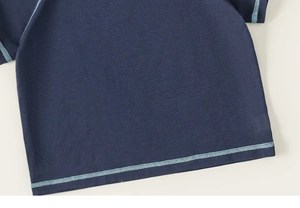 Detail of navy knit t-shirt featuring contrast mint green stitching and premium fabric