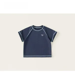 Detail of dark blue kids cotton T-shirt featuring contrast stitching and heart embroidery