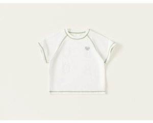 Detailed close-up of cream cotton t-shirt featuring contrast green stitching and text