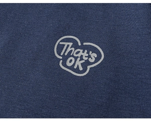 Close-up of navy blue cotton T-shirt showing fine knit texture and That's ok print