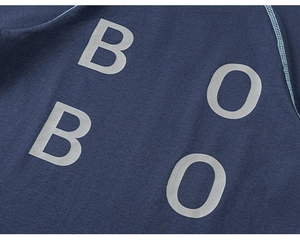 Detail of navy knit fabric with grey BBOO lettering and fine light blue stitching